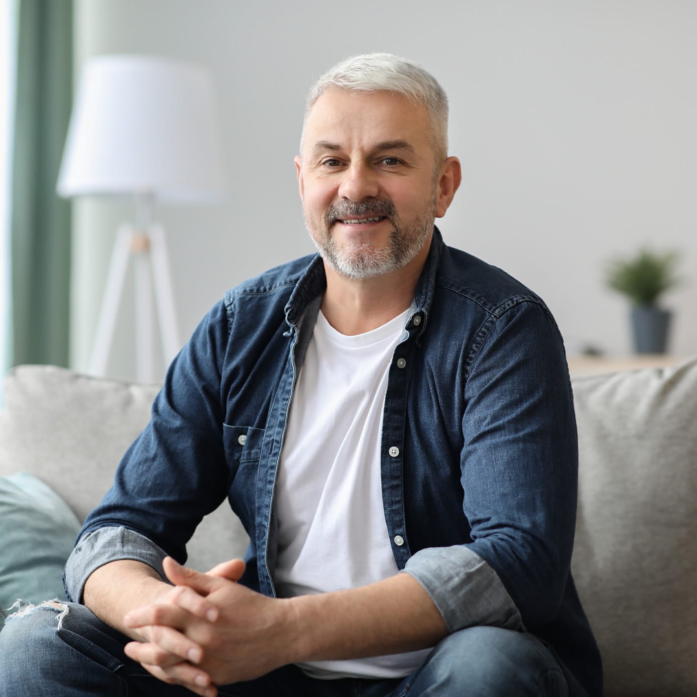 man sitting on a couch smiling